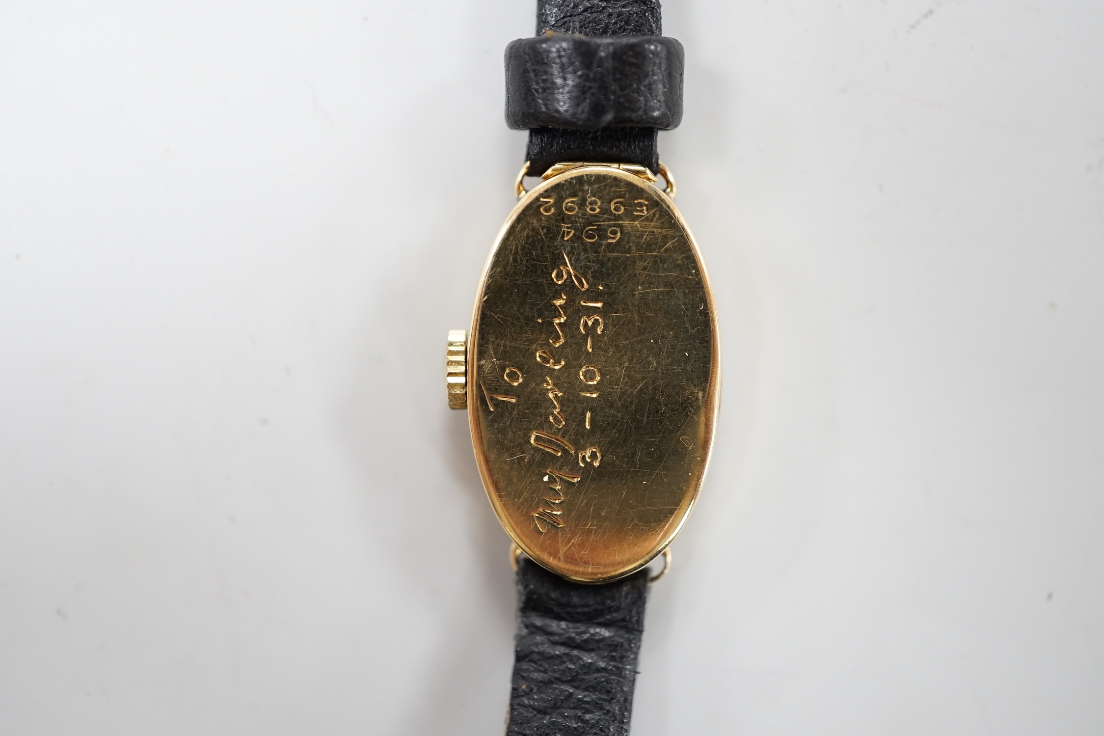 A lady's 1930's 18ct gold oval Rolex manual wind wrist watch, with Roman dial and Rolex Prima movement, with engraved inscription and associated strap, with service receipt.